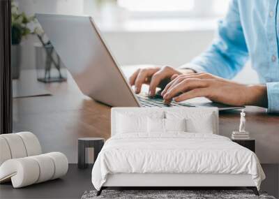 Hands of young contemporary office manager over laptop keypad during work Wall mural