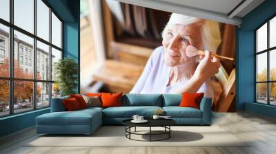 Happy senior female with short white hair looking at beautician Wall mural