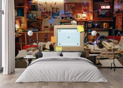 Horizontal image of workplace with computer monitor and documents on table in garage Wall mural