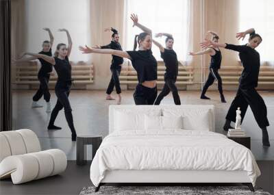 Horizontal shot of contemporary dance team learning new movements in their rehearsal moves Wall mural