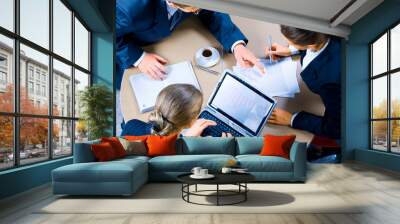 Image of three business people working at meeting Wall mural