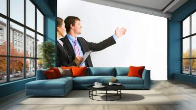 portrait of businessman pointing at wall with her assistant Wall mural