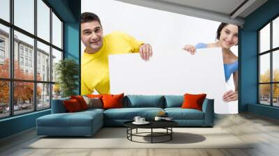 smiling couple holding blank poster and looking at camera Wall mural