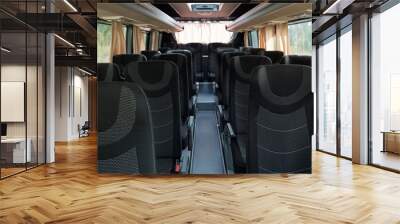 Two rows of grey and balck double seats and long aisle between them inside intercity bus Wall mural