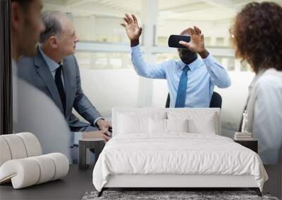 Young businessman with vr headset taking part in web conference with his colleagues around him Wall mural