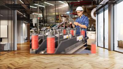 Young engineer or technician with tablet searching for technical information Wall mural