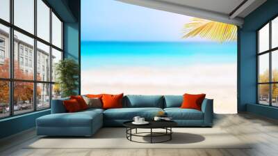 Panorama of summer beach and blurred blue sky with leaves of coconut palm tree. Wall mural