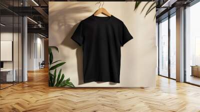 blank black t-shirt mockup on a wooden hanger against a clean wall background Wall mural