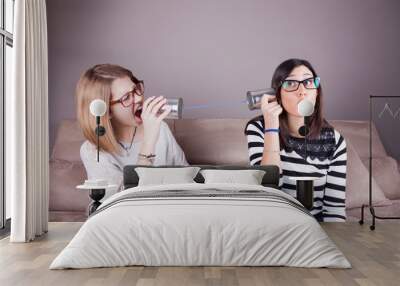 blonde and brunette women talking with tin can telephone Wall mural