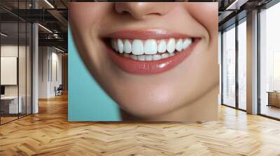 A close-up of a woman's radiant smile with perfectly white teeth, set against a smooth light blue background, symbolizing health and confidence. Wall mural