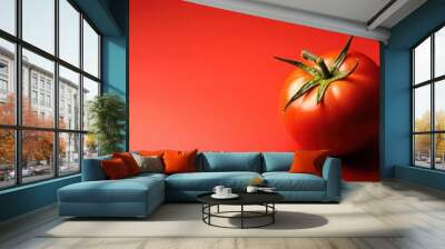 A fresh bush tomato on a vibrant red background, with space for text. Wall mural