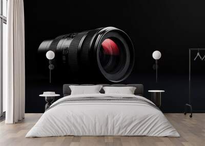 A professional camera lens isolated on a black background, showcasing modern photography equipment. Wall mural