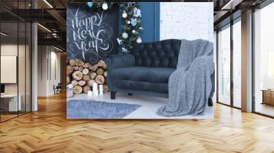 Beautiful New Year's decor. Preparing for the new year, a beautiful room framed for the new year, sofa, blanket, fireplace, inscription in chalk - happy new year Wall mural