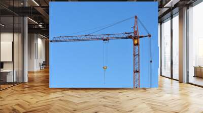 Construction crane against the blue sky Wall mural