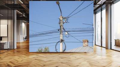 A power line pole with wires hanging from it Wall mural