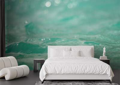 Gentle waves glisten under sunlight on a clear, calm day at a serene beach Wall mural