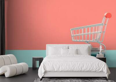 Minimalistic image of an empty shopping cart set against a pastel pink and blue background, representing retail and consumerism in a modern, vibrant context. Wall mural