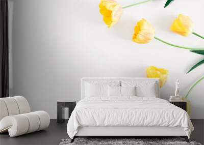 Beautiful composition of tulip, spring flowers. Yellow tulips flowers on white background. Valentine's Day, Easter, 8th march, Happy Women's Day, Mother's Day. Flat lay, top view, copy space Wall mural