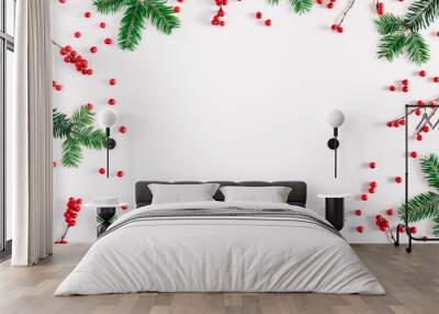 Christmas holiday composition. Xmas decorations, fir tree branches and red berries on white background. New Year, winter concept. Flat lay, top view, copy space Wall mural