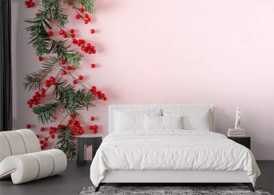 Christmas modern composition. Fir tree branches, red berries, Xmas decorations on pastel pink background. Christmas, New Year, winter concept. Flat lay, top view, copy space Wall mural