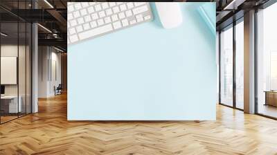 Female home office workplace with keyboard, notepad, notebook on pastel blue background. Business minimal concept for women. Flat lay, top view, copy space Wall mural