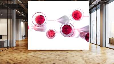 Glasses with pink red wine and sparkling shadows on white background. Shadows from glasses of wine on table. Flat lay, top view, copy space Wall mural