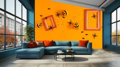 Halloween background. Flat lay. Top view of photo frame , Halloween decorations, пауки и тыквы on orange background. Halloween concept Wall mural