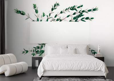 Modern composition of eucalyptus. Pattern made of eucalyptus branches and leaves on white background. Flat lay, top view, copy space Wall mural