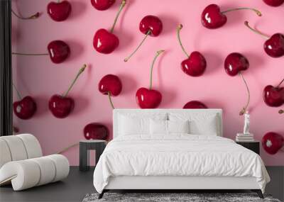 Red cherry on pink background. Ripe red cherry berries as background. Flat lay, top view, copy space Wall mural