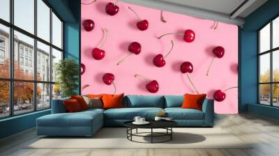 Red cherry on pink background. Ripe red cherry berries as background. Flat lay, top view, copy space Wall mural