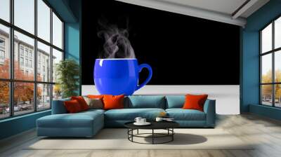 Steaming coffee cup on black background. Blue сoffee cup with steam. Smoke from hot coffee. Front view, copy space Wall mural