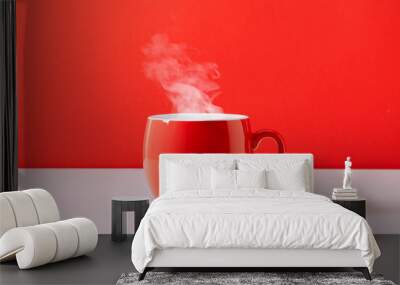 Steaming coffee cup on red background. Red сoffee cup with steam. Front view, copy space Wall mural