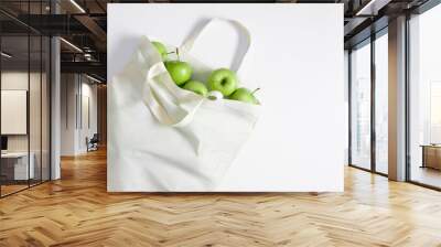 White tote bag mockup with green apples on white table background. Flat lay, top view, copy space, mockup Wall mural