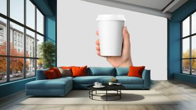 Mockup of male hand holding a Coffee paper cup isolated on light grey background.  Wall mural