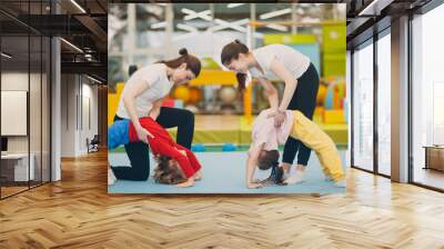 Kids doing exercise bridge in gym at kindergarten or elementary school. Children sport and fitness concept Wall mural