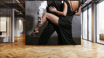 Young pretty woman in black dress and man dance tango Wall mural