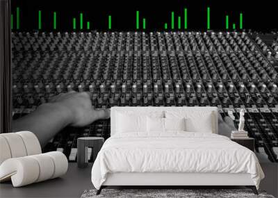 hands of sound engineer working on recording studio mixer, show green led level meter Wall mural