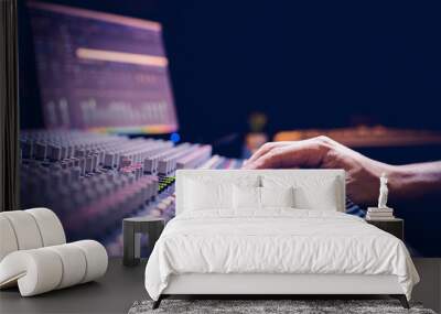 male producer, sound engineer hands working on audio mixing console in broadcasting, recording studio Wall mural