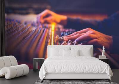 male producer, sound engineer hands working on audio mixing console in broadcasting, recording studio Wall mural