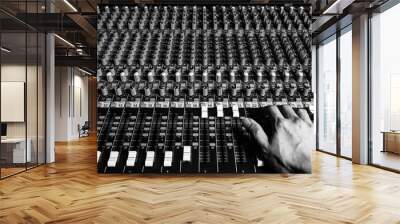 right hand of sound engineer working on recording studio mixer. bw filter Wall mural