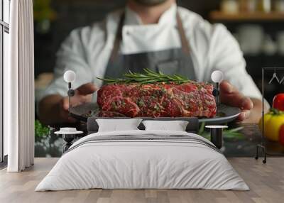 fresh raw meat. Chef holding fresh raw meat on plate with blur background Wall mural