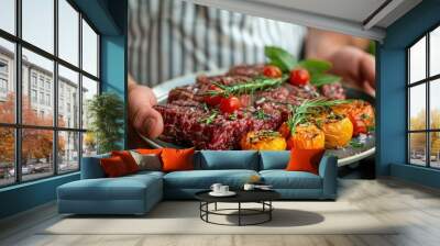 fresh raw meat. Chef holding fresh raw meat on plate with blur background Wall mural