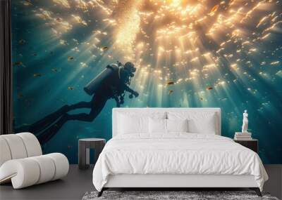 Life-giving sunlight filters through the water, casting radiant beams that illuminate the underwater world. A scuba diver's silhouette floats in the blue depths Wall mural