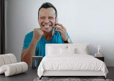 Portrait of handsome young business man, student, happy guy, excited employee, using cell phone, smiling, having pleasant conversation, isolated on white background. Human emotions and expressions. Wall mural