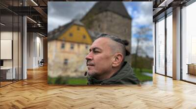 Tourist poses in front of Medieval knight's castle, Siedlicin tower in Poland, Lower Silesia Wall mural