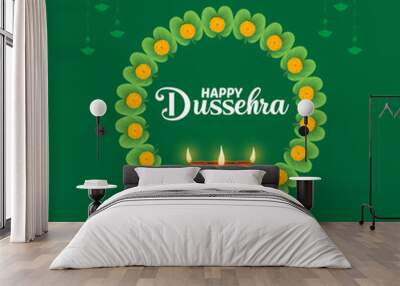 A green background with a circular design of green leaves and yellow marigolds centered around a diya with three lit wicks HAPPY DUSSEHRA and a celebratory message are displayed Wall mural