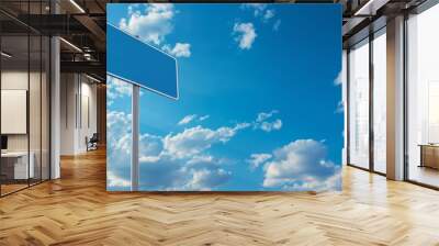 Blank blue traffic sign against blue sky background with white clouds. Mockup traffic sign with copy space. Wall mural