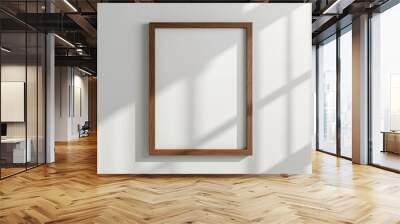 Blank wooden frame hanging on the white wall. Wall mural