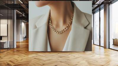 Close up woman in light beige suit wearing golden chain necklace. Wall mural