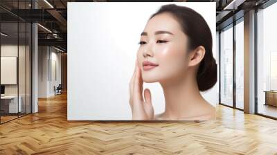 Portrait of beauty asian woman with fair perfect healthy lift glowing skin hand touching chin isolated on white background. Wall mural